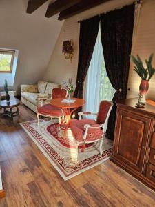 a living room with a table and a couch at Vila Mažoji apartamentai in Palanga