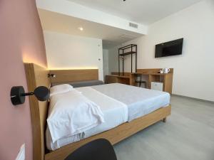a bedroom with a bed and a television in it at Le Camere Del Centro in Matera +24 photos