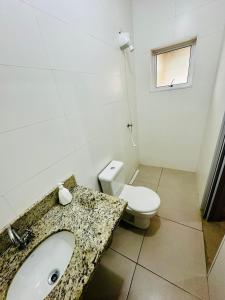 a bathroom with a sink and a toilet at Casa com Vista do Mar e Montanha in Peruíbe +60 photos