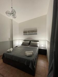 a bedroom with a bed with two towels on it at Diletta house in Catania