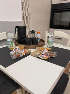 a table with some food and water bottles on it at Diletta house in Catania