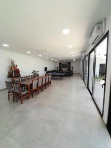 a large room with a dining table and chairs at Espectacular Casa Quinta en Riachuelo Cts in Laguna Brava