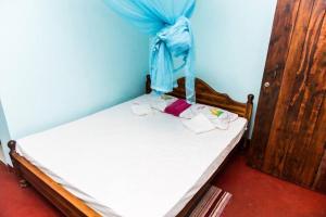 Ένα ή περισσότερα κρεβάτια σε δωμάτιο στο Raja Guest House