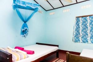 Ένα ή περισσότερα κρεβάτια σε δωμάτιο στο Raja Guest House