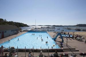 a large swimming pool with people in the water at Paradis på Sørlandet 3 in Kristiansand