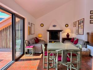 a living room with a table and a couch at Porto Ercole Maison vista mare in Cala Galera