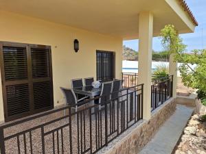 a balcony with a table and chairs on it at Villa cerca de Valencia con piscina junto a la montaña in Vilamarxant