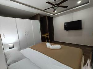 a bedroom with a bed and a flat screen tv at Moderno 1BR sauna gimnasio alberca a cuadras de la 5ta av centro in Playa del Carmen
