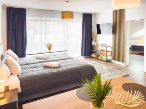 a bedroom with a large bed and a large window at ImmoStay Waterfront Apartments - Balkon über Bremen & Parking in Bremen