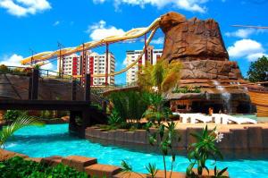 a water park with a bridge and a water slide at Piazza diRoma com acesso ao Acqua Park e Splash - Temporada CN Adriele in Caldas Novas