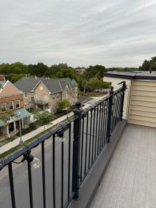 a balcony with a black railing and houses at LUX Entire House 4BR in DC - Private Garage in Washington