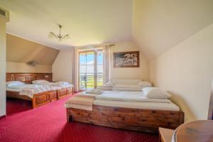 a bedroom with two beds and a window at Pensjonat Sekuła*** in Bukowina Tatrzańska