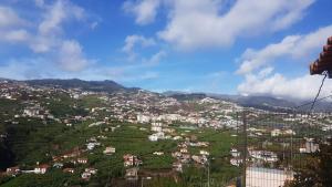 a view of a town on a hillside at Paraíso Pico da Torre in Câmara de Lobos