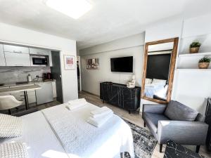 a living room with a bed and a couch and a mirror at The Olive Loft in Vigo