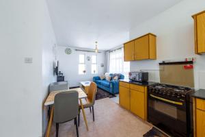 a kitchen with a table and a dining room at Serene Retreat 2 Bedroom with Pool, Netflix Fast Wifi and Gym in Nairobi