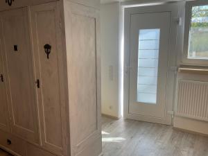 a room with a wooden door and a window at Carmen diem in Altshausen