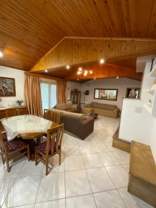 a large living room with a table and a couch at Skiathos Island Villas in Skiathos