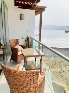 a patio with a table and chairs on a balcony at e-t*| Apartamento frente al mar in Cerro Azul