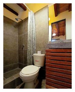 a bathroom with a toilet and a shower at Casa Naranja in Máncora +52 photos