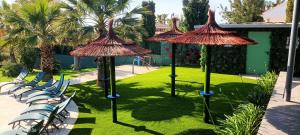 a group of chairs and umbrellas in a yard at The Blue Diamond Villa-25min to Valencia in Turís