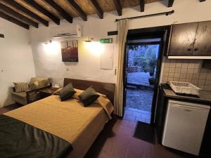 a bedroom with a bed and a door to a yard at Enipnion Apartments in Kakopetria