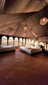 a room with two beds in a tent at Merzouga Top Camping in Merzouga