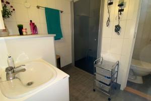 a bathroom with a sink and a shower and a toilet at Cozy apartment near city center and nature in Kristiansund +26 photos