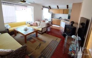 a living room with a couch and a table at Vacation Home "Cehic" in Kulen Vakuf