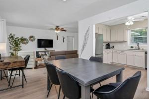 a kitchen and living room with a table and chairs at Blue Park Nest - 3BR 2BA in West Columbia