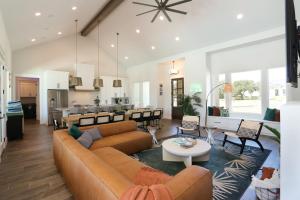 a living room with a couch and a table at Heated Pool Movie Theater Hot Tub Games Sleeps 28 in Concan