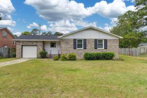 a brick house with a garage in a yard at Blue Park Nest - 3BR 2BA in West Columbia