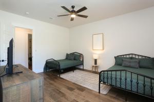 a living room with a bed and a tv at Heated Pool Movie Theater Hot Tub Games Sleeps 28 in Concan