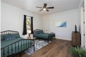 a bedroom with two beds and a ceiling fan at Heated Pool Movie Theater Hot Tub Games Sleeps 28 in Concan +43 photos