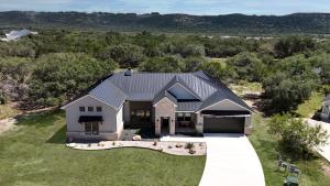 an aerial view of a house with a garage at Heated Pool Movie Theater Hot Tub Games Sleeps 28 in Concan