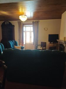 a living room with a couch and a window at Cruzeiro - Guest House in Vale de Porco