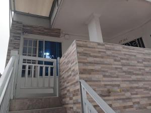 a house with a white door and a staircase at Habitación Independiente El paraíso - Cerca al Gran Malecón del Rio-Barranquilla in Barranquilla