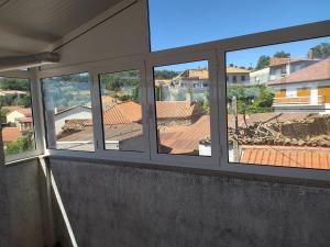 a group of windows in a building with a view at Cruzeiro - Guest House in Vale de Porco +6 photos