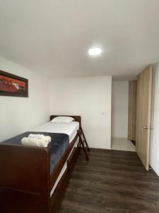 a bedroom with a bed in a room with a door at Espectacular apartamento en armenia zona norte in Armenia