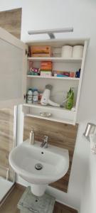 a bathroom with a white sink in a room at La Casita El Carmen in Quintanar de la Orden