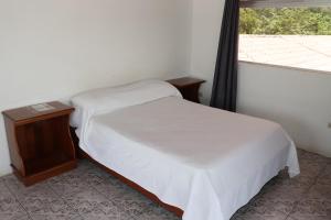 Postel nebo postele na pokoji v ubytování Hotel Samoa del Sur
