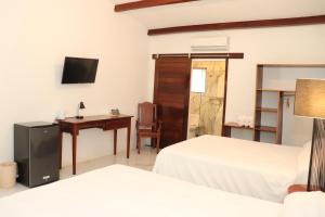 Postel nebo postele na pokoji v ubytování Hotel Samoa del Sur