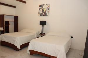 Postel nebo postele na pokoji v ubytování Hotel Samoa del Sur