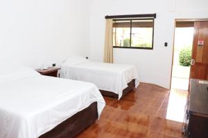 Postel nebo postele na pokoji v ubytování Hotel Samoa del Sur