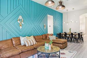 a living room with a brown couch and a blue wall at 4BD 2BA Saginaw Sanctuary - Pool Firepit Laundry in Saginaw +31 photos
