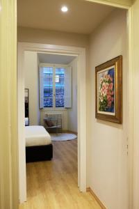 a bedroom with a bed and a painting on the wall at Strozzi Luxury Apartment in Florence
