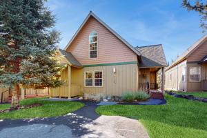 a home with a tree and a house at Serenity at Eagle Crest in Redmond