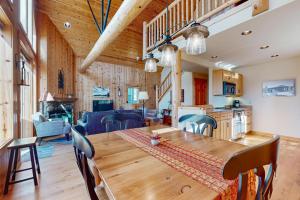 a dining room and kitchen with a wooden table and chairs at Serenity at Eagle Crest in Redmond