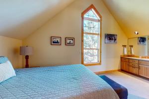 a bedroom with a large bed and a window at Serenity at Eagle Crest in Redmond +28 photos