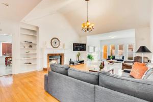 a living room with a couch and a fireplace at Heated Pool ATL 5BR Modern Sanctuary in Conyers