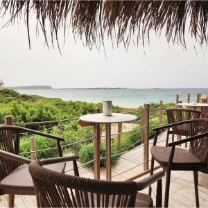 a patio with chairs and a table with a view of the ocean at Il Castello in Seneghe